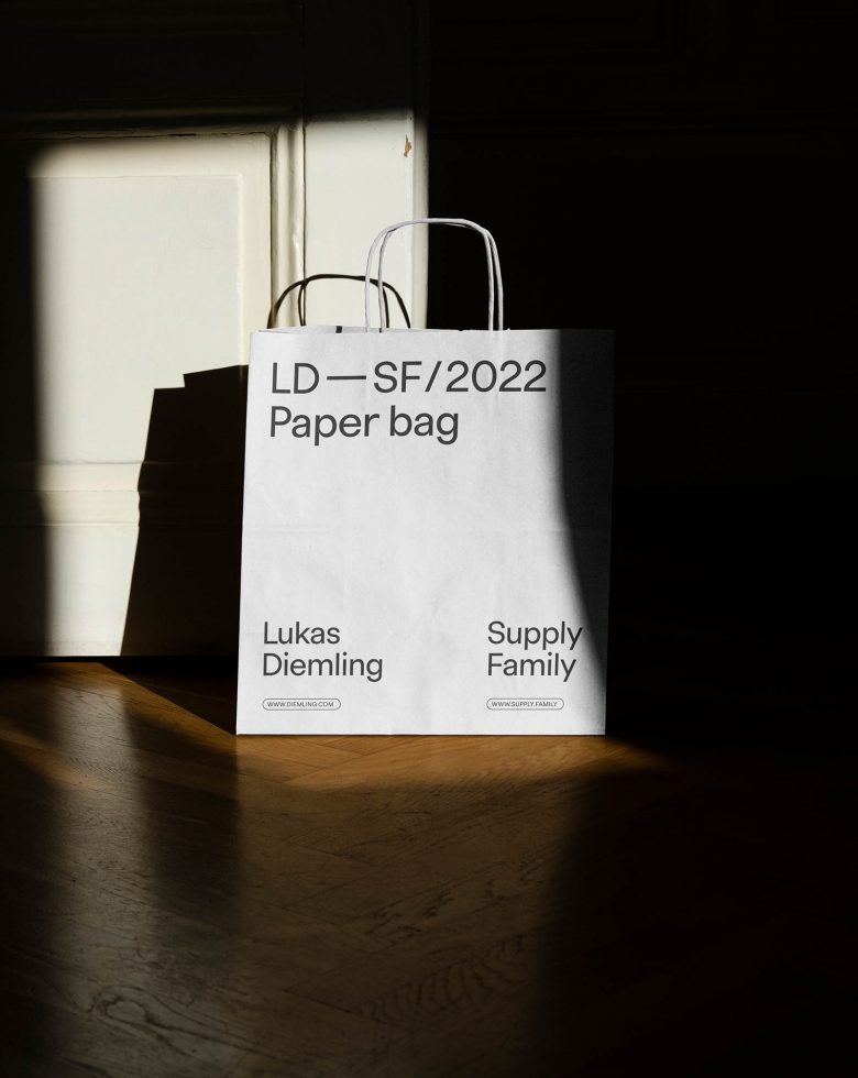 White paper bag with typography design cast in shadow and light, suitable for Mockup category, displays font and branding potential.