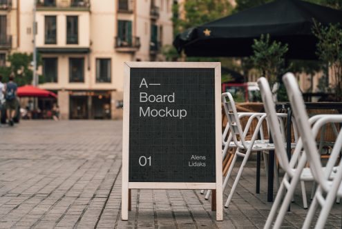 A-board signage mockup in outdoor cafe setting, showcasing display design possibilities for urban environment advertising.