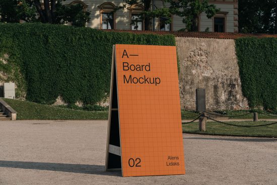 Outdoor A-board mockup standing in park with green hedge background for advertising and signage design presentation.