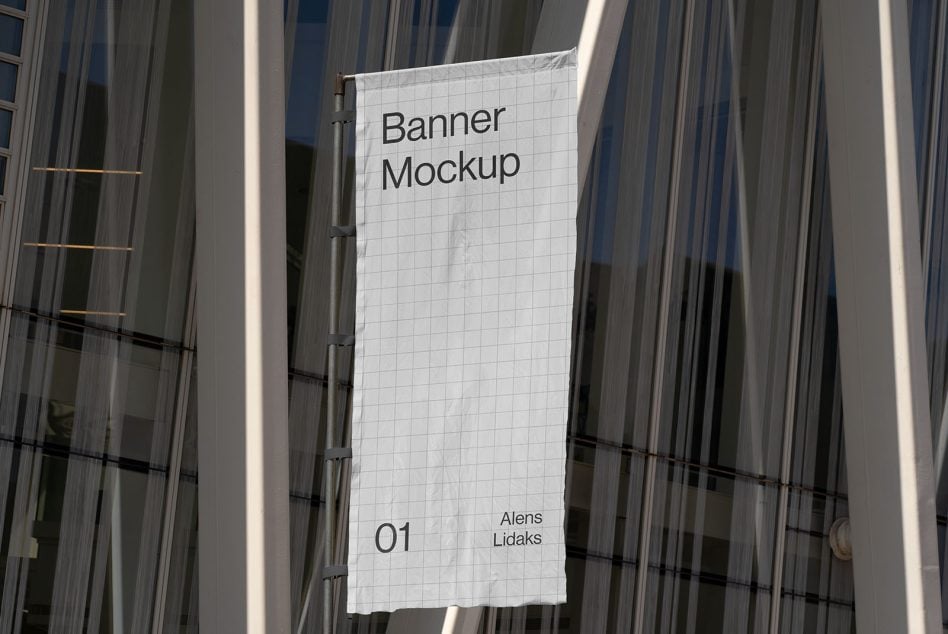 White vertical banner hanging from metal frame on striped glass building exterior