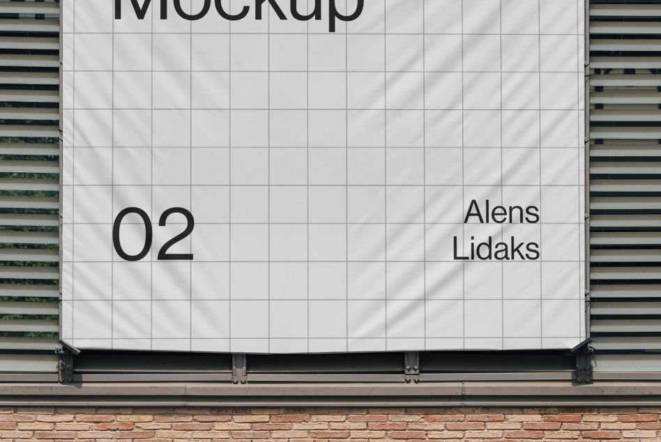 Close-up of white billboard mounted on striped metal building facade with shadow