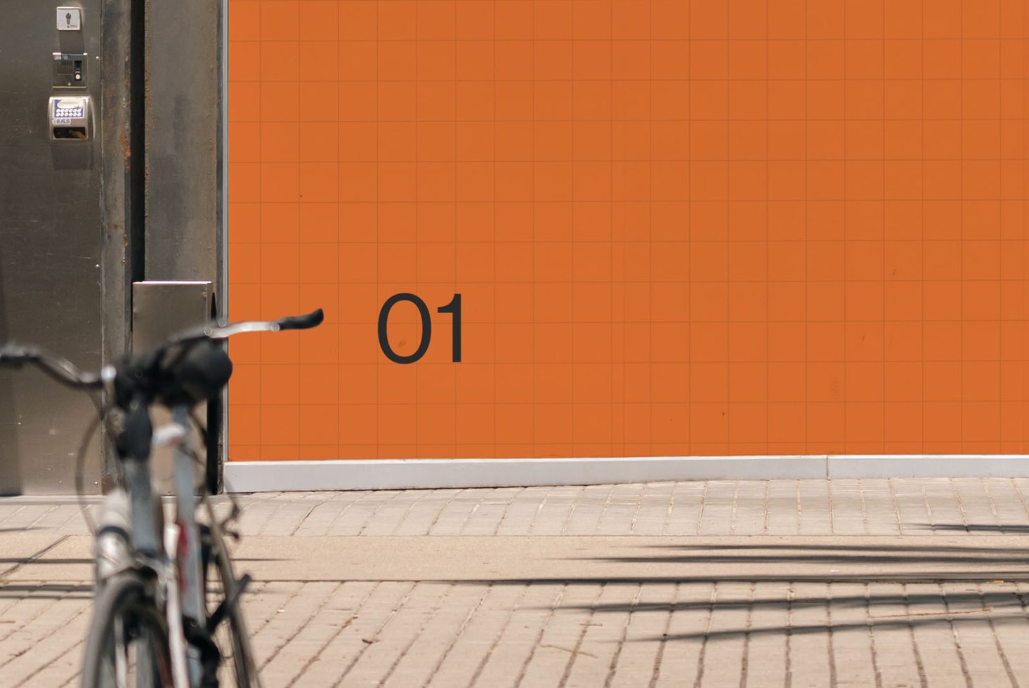 Urban mockup with orange tiled wall and parked bicycle, clear space for branding, high-resolution billboard template.