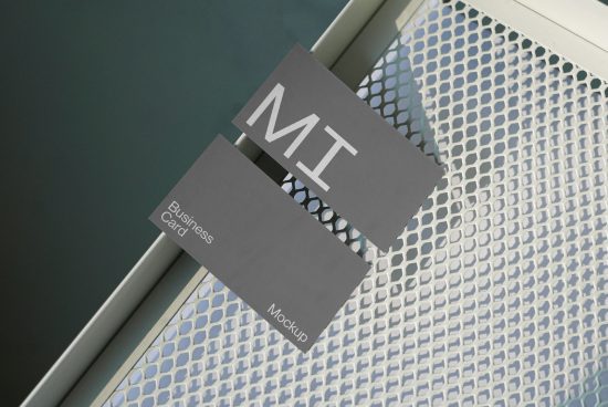 Floating business card mockup on a metallic grate background with geometric design, showcasing modern branding presentation for designers.