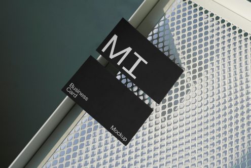 Elegant black business card mockup with reflective surface for designers, showcasing modern typography design on textured background.