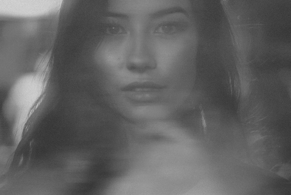 Monochrome portrait of a woman, blurred effect, artistic photography, subtle emotion, ideal for graphic design use.