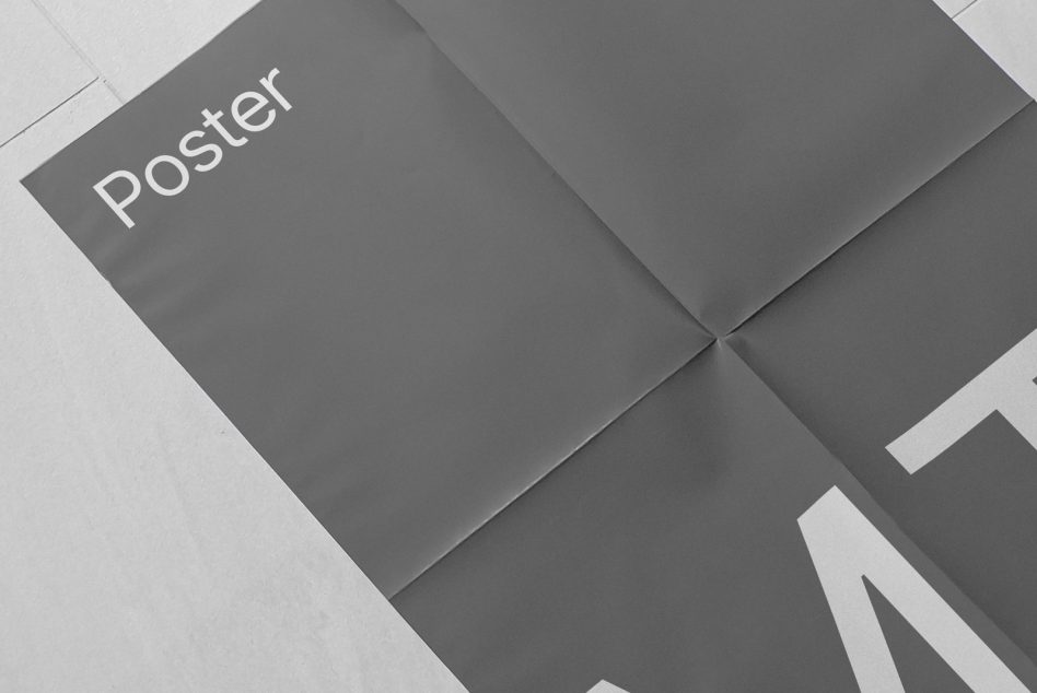 Folded poster mockup in grayscale to showcase design, with a focus on typography and layout, ideal for presentations and portfolio.