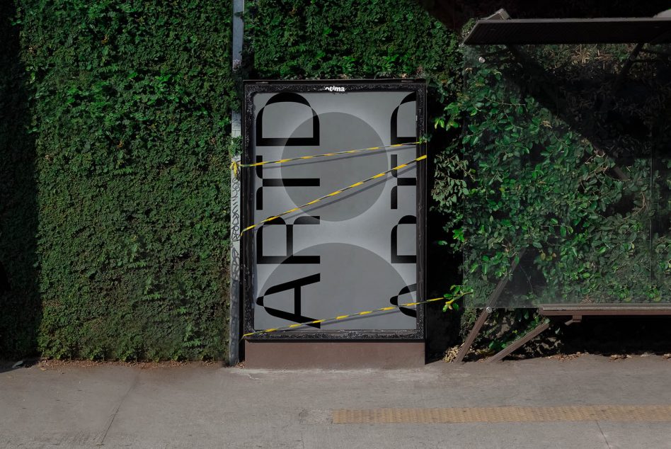 Urban bus stop with a bold graphic design poster mockup, green leafy background, and caution tape accents. Perfect for display advertising presentations.