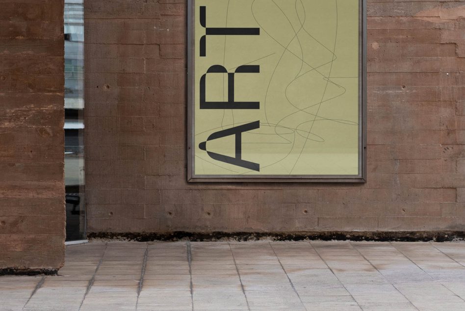 Yellow wayfinding sign with black vertical text on brick building exterior