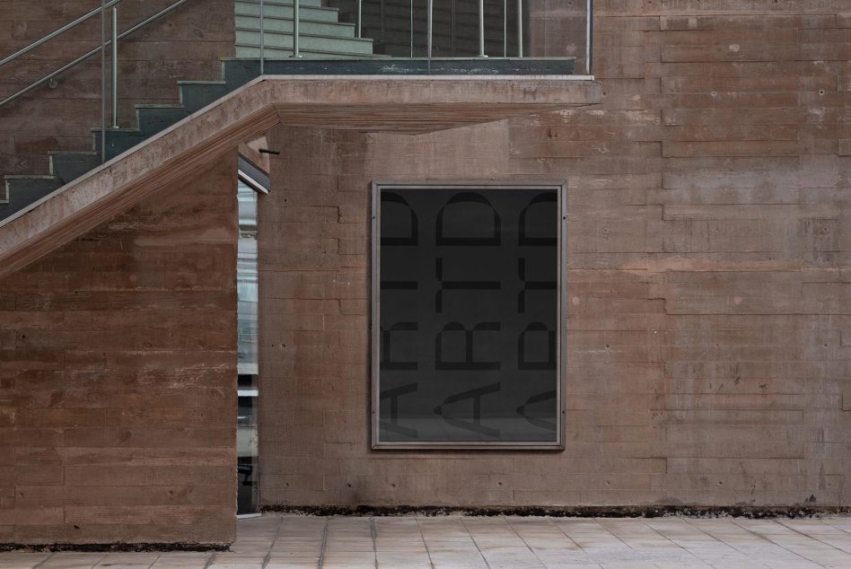 Square window on brick building exterior with dark geometric pattern overlay reflection
