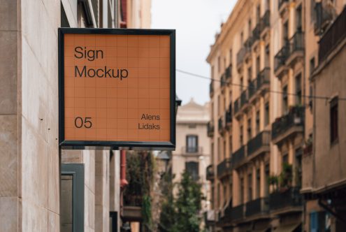 Outdoor street sign mockup on building facade with editable design template, ideal for presentations and branding in urban settings.