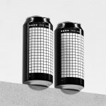 Two sleek beverage can mockups with grid patterns on a light textured background, perfect for branding presentations for designers.