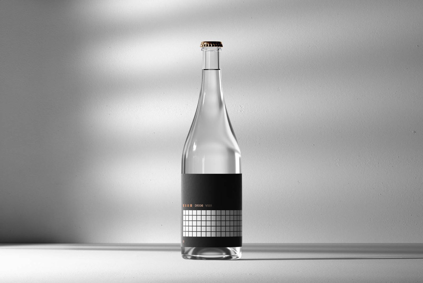 Minimalist clear glass bottle mockup with black label design on a bright background with subtle shadows, ideal for branding and packaging presentations.