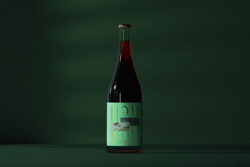 Elegant wine bottle on dark green background, ideal for mockups and packaging design with clear label space for branding and typography.