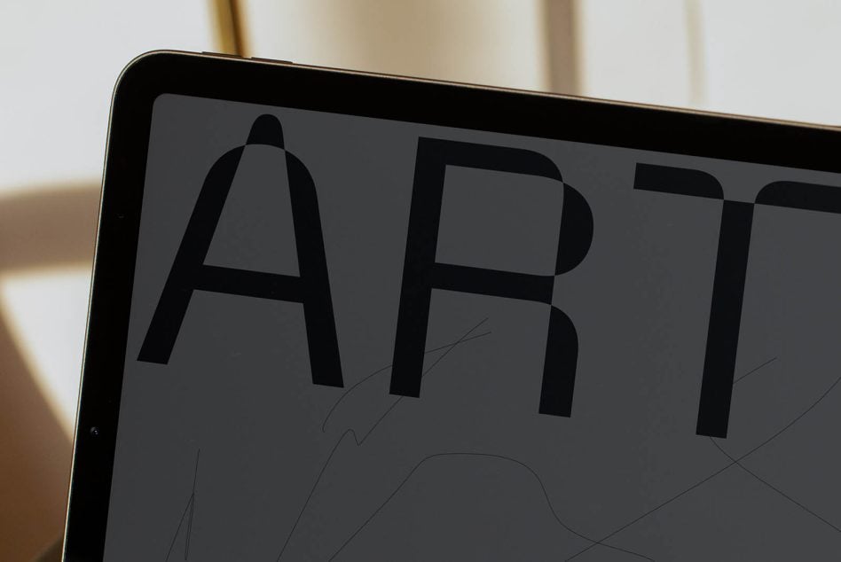 Tablet screen showing sans serif font with sketch overlays in neutral tones