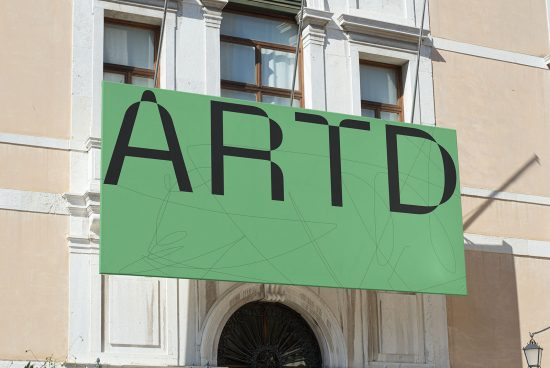 Outdoor billboard mockup with large green ART typography over building entrance for advertising design presentation.