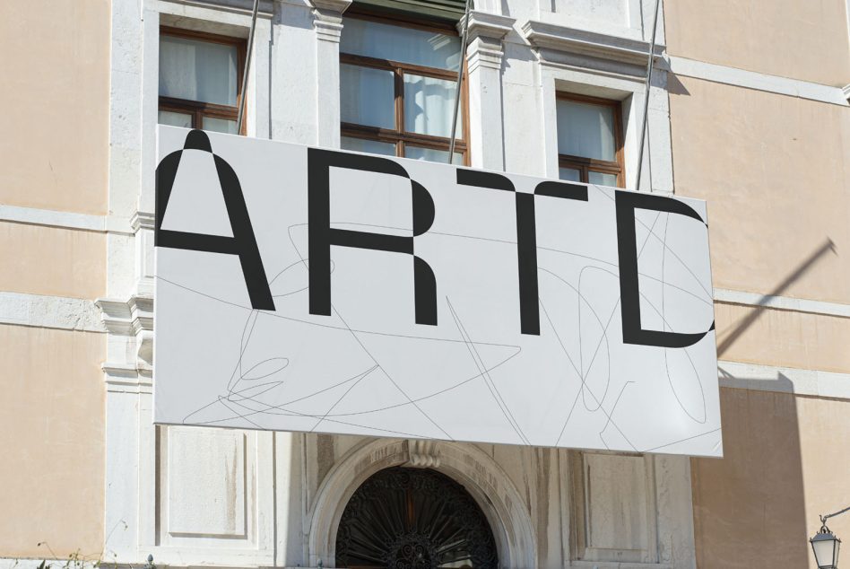 White horizontal storefront sign with bold black letters over classical facade