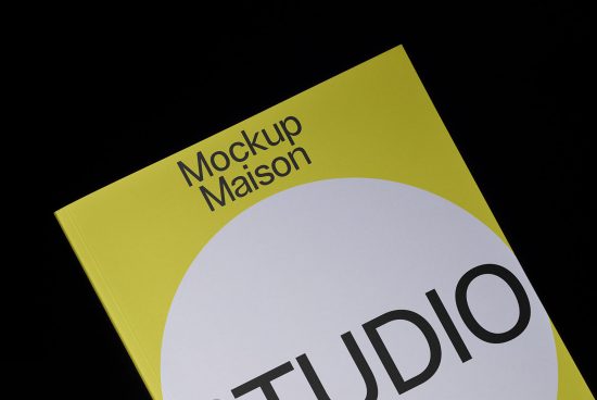 Yellow book cover mockup with white circle graphic design on a black background, ideal for presentation template for designers.