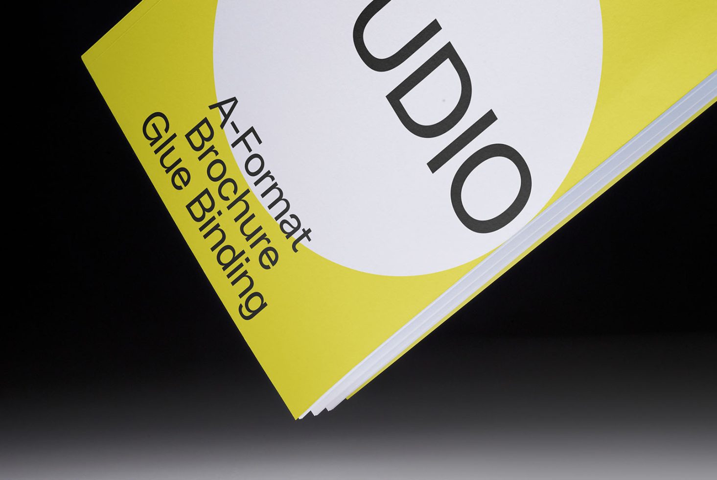 Brochure mockup on black background with yellow accent, A-format glue binding visible, ideal for graphics and templates display for designers.