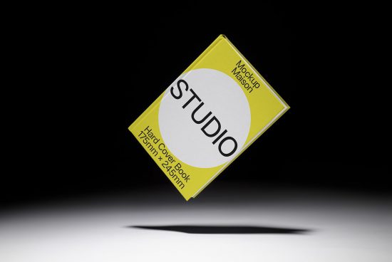 Floating yellow book cover mockup with studio branding on a dark background, ideal for presentation design asset.