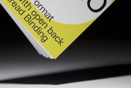 Close-up view of a magazine mockup with a yellow accent design, spotlighting high-quality print, and binding details.