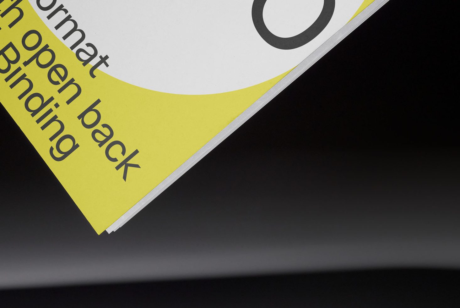 Close-up view of a graphic design mockup with a focus on text and binding, showcasing print design, layout, typography.