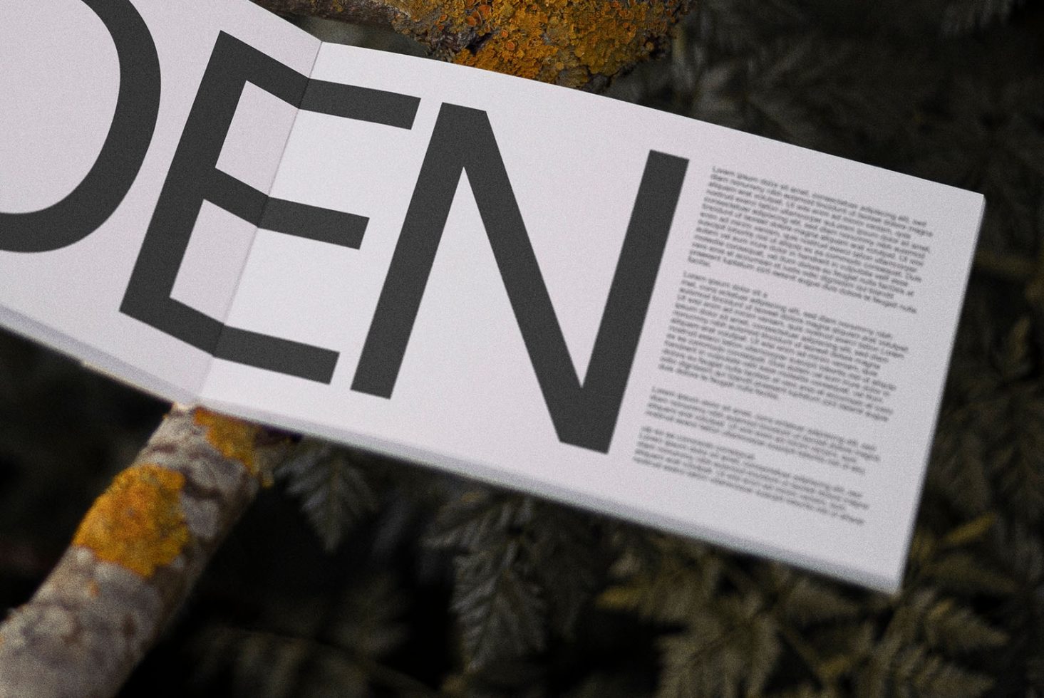 Paper with bold typography design mockup overlay on textured branch, showcasing font style in natural setting for visual design.