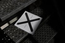 White square packaging mockup with large black cross symbol, minimalist design