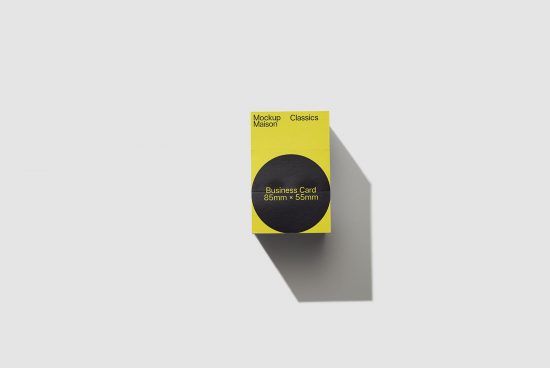 Modern business card mockup design with yellow background and a black circle displayed with a soft shadow for showcasing graphic design.
