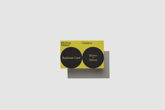 Elegant business card mockup design with black and yellow color scheme, presented on a grey surface, ideal for designers and branding presentations.