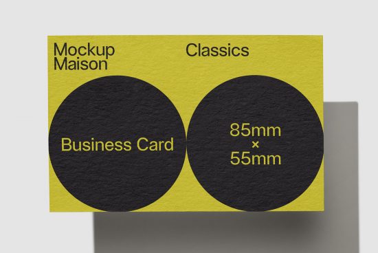 Yellow and black business card mockup design on gray background, showcasing standard dimensions of 85mm x 55mm for graphic designers.