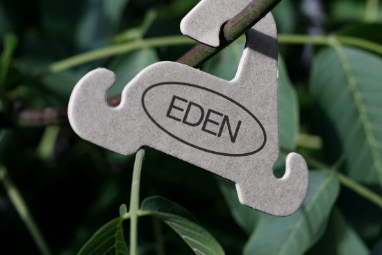 Close-up of laser-cut wooden tool shape with custom branding hanging on chain, ideal for mockup presentations and branding projects.