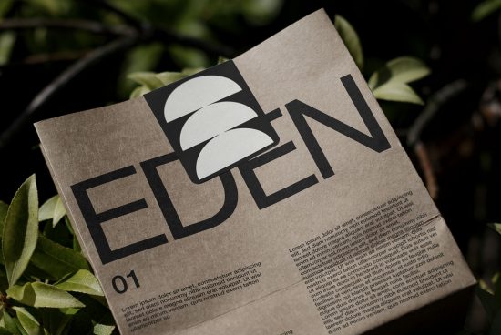 Eco-friendly packaging mockup with bold typography for branding, set against green foliage background, perfect for sustainable design presentations.