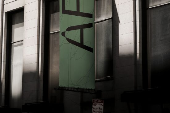 Urban scene with hanging green banner mockup on building facade, minimalistic design, shadow play, suitable for ads and graphics display.