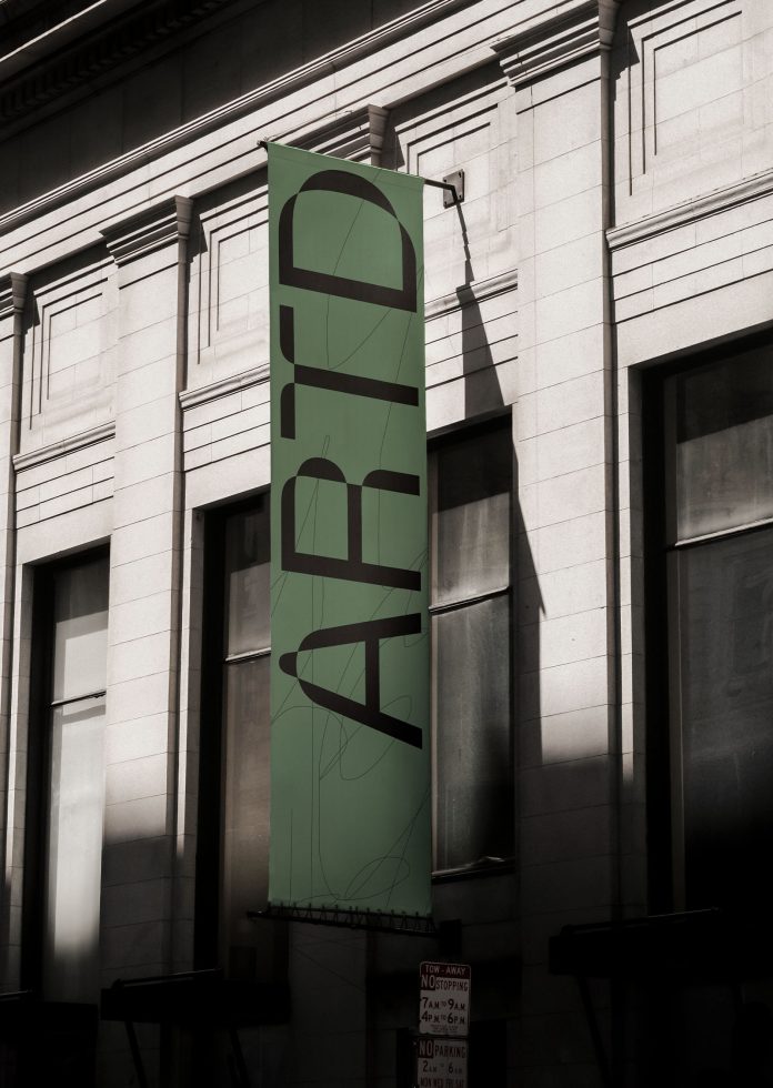 Vertical banner mockup on building facade with unique modern typography design for outdoor advertising and branding.