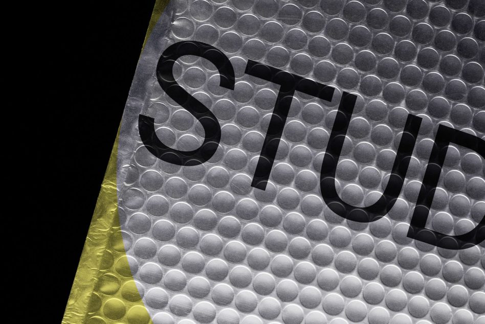 Clear bubble wrap mailer with black text reading STUDIO on translucent material with yellow edge