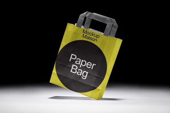 Bright yellow paper bag mockup with black circle design on a dark background, perfect for packaging presentations and branding projects.
