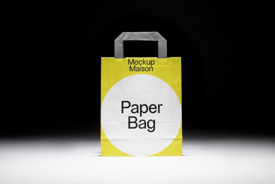 Yellow paper bag mockup with simple label design on a dark background for product design and branding presentations.