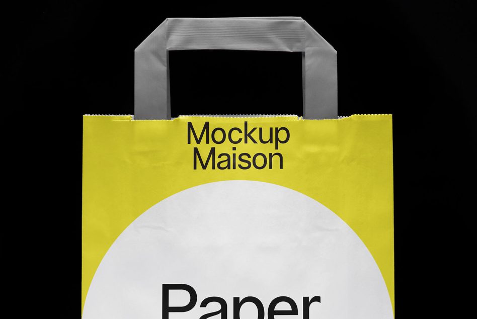 Large paper bag with metal handles, yellow design showing partial Paper text