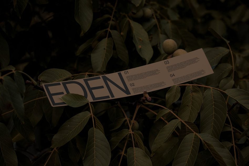 Brown kraft paper ribbon with EDEN logo among dark foliage