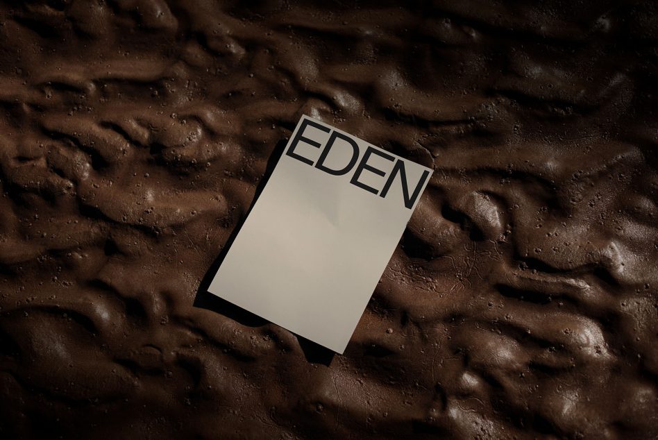 White business card mockup with EDEN on textured brown surface