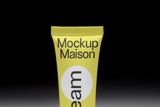 Yellow tube packaging mockup with customizable label design on a dark background, ideal for designers creating cosmetics branding.