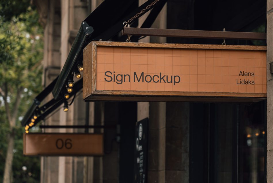 Realistic sign mockup hanging on storefront, editable design for branding, outdoor advertising in urban setting, ideal for graphic designers.