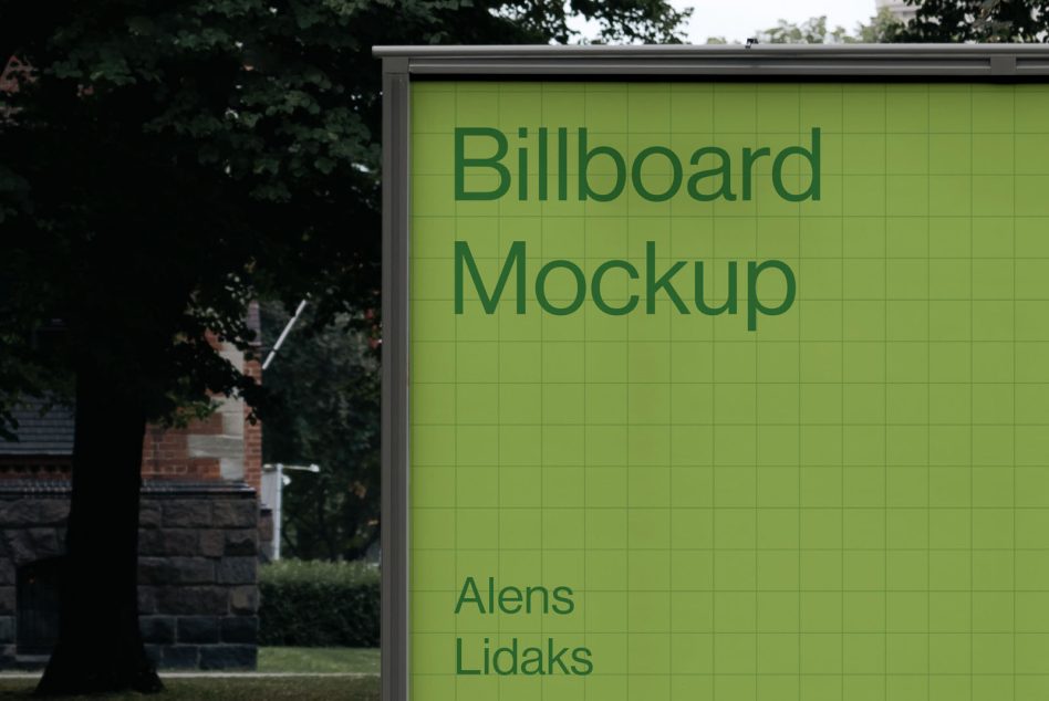 Outdoor billboard mockup in a green hue with clear text for design presentations, set against a natural background with trees.