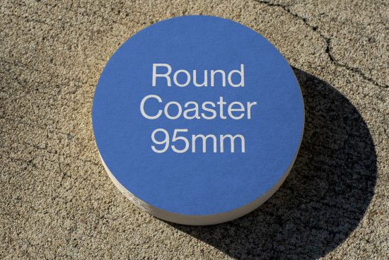 Blue round coaster mockup, 95mm, simple design on textured background, ideal for branding presentation and portfolio display.