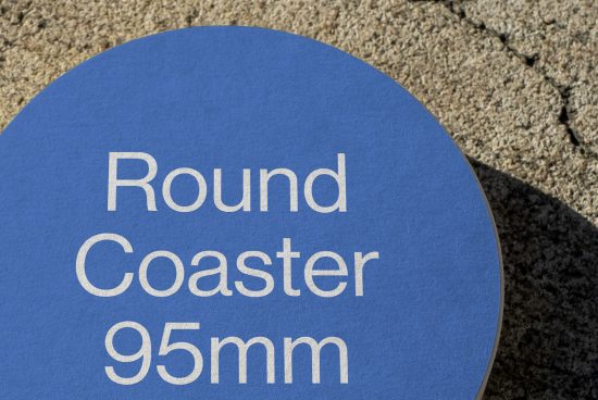 Blue round coaster mockup with white text design on textured background, ideal for branding presentations, 95mm diameter.