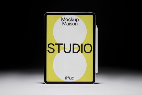 iPad mockup with stylus on a black background showcasing a graphic design studio advertisement, perfect for digital design presentations.