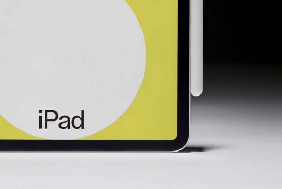 Close-up view of a modern tablet corner with sleek design, displaying partial branding, ideal for mockup graphics, placed on a dual-tone background.