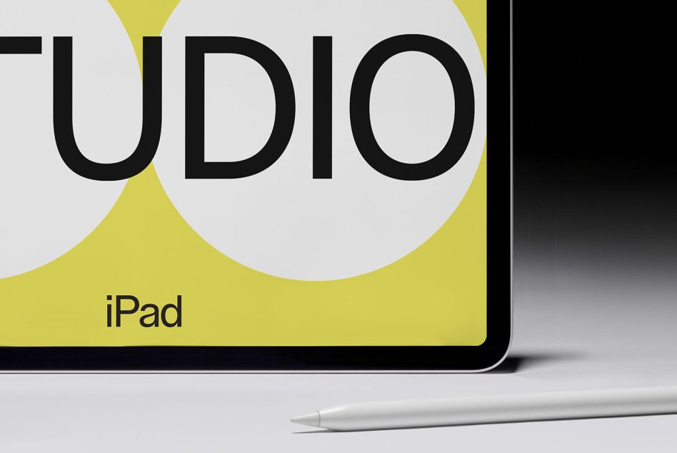 iPad screen showing word STUDIO with bold typography design, Apple Pencil in front, ideal mockup for graphic presentation.