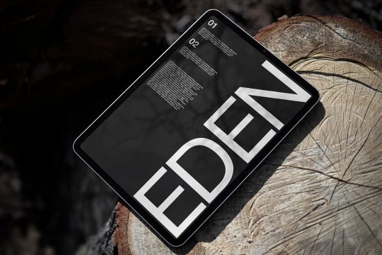 Modern tablet mockup showcasing bold typography design on a screen, positioned on textured wood background, ideal for presentations and branding.