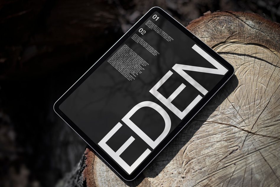 Modern tablet mockup showcasing bold typography design on a screen, positioned on textured wood background, ideal for presentations and branding.